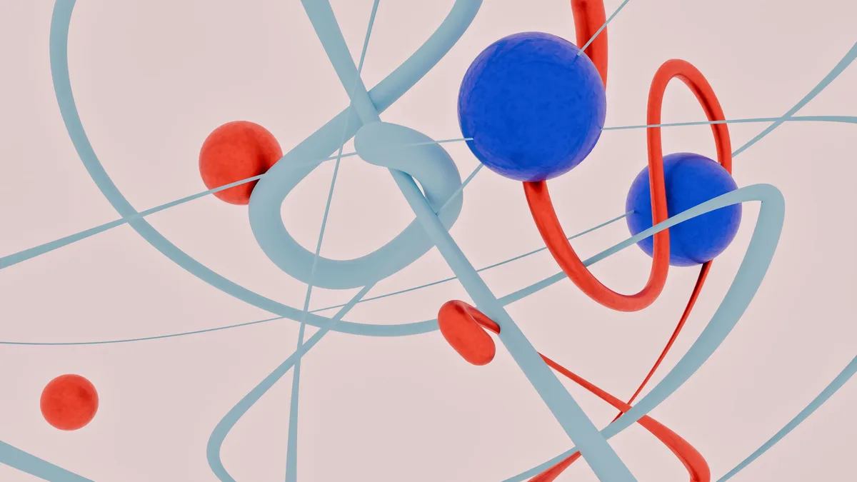 A stylized representation of atomic structures, featuring blue spheres representing atoms, red lines symbolizing electrons, and light blue lines indicating the orbits of electrons around the nucleus.